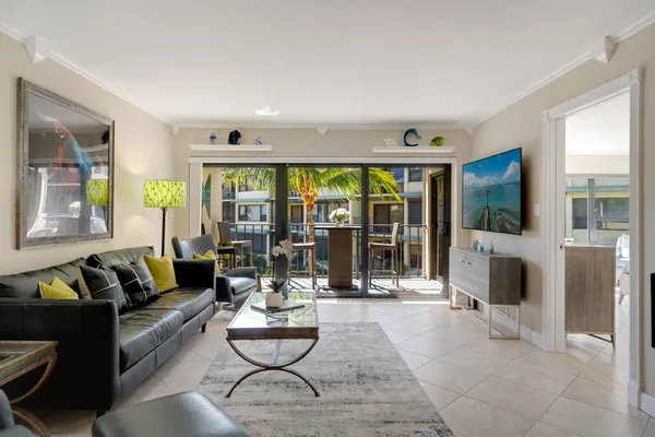a living room with fireplace furniture and a large window