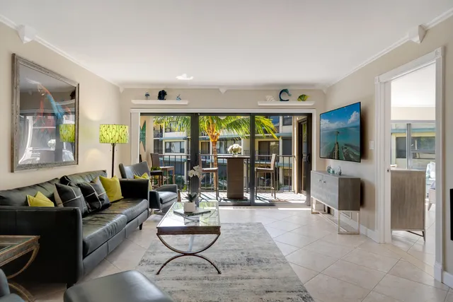 a living room with fireplace furniture and a large window