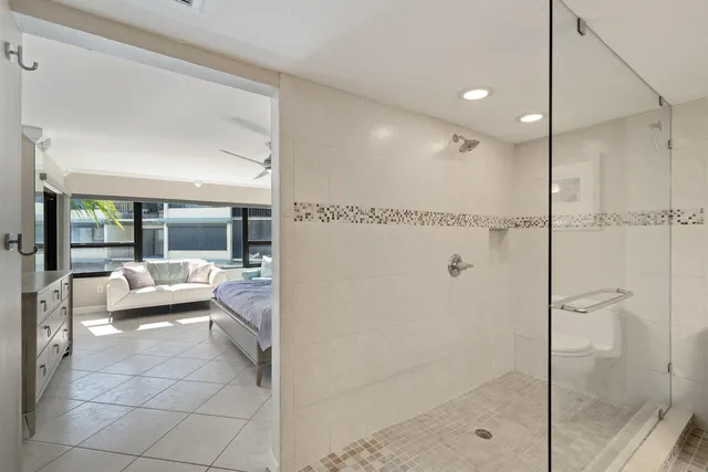 a bedroom with a large bed and a couch