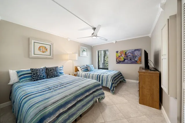 a large bathroom with a double vanity sink a toilet and a large mirror