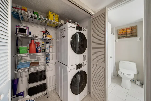 a bedroom with two beds and a chandelier