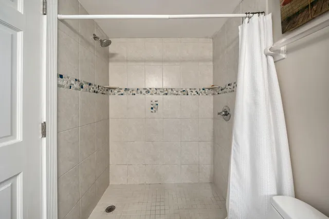 a bathroom with a granite countertop sink and a large mirror