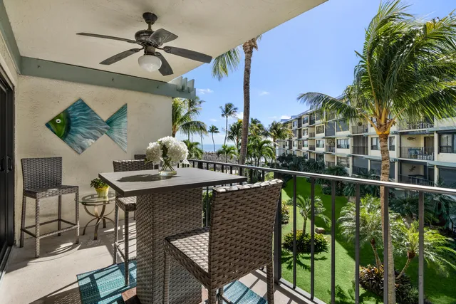 a view of a hallway with wooden floor and a living room