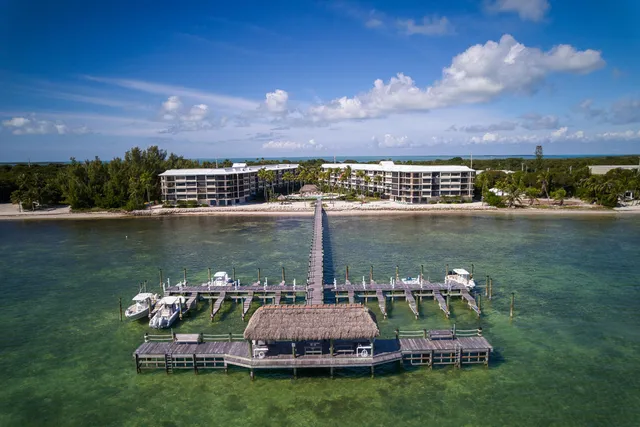 a kitchen with a refrigerator and a stove top oven