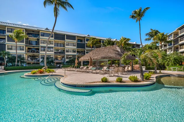 a view of a house with swimming pool and porch