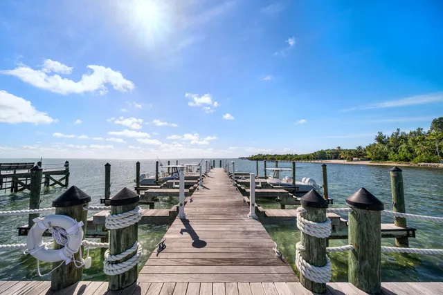 a view of a terrace with lawn chairs