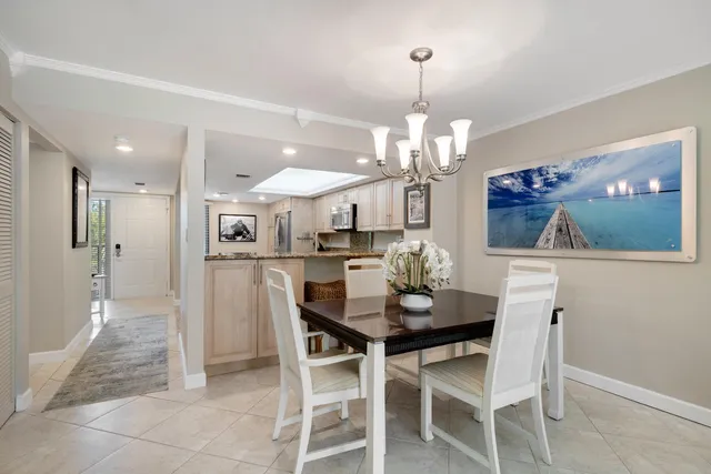 a view of a dining room with furniture and chandelier