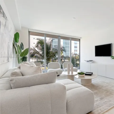 a living room with furniture and wall painting