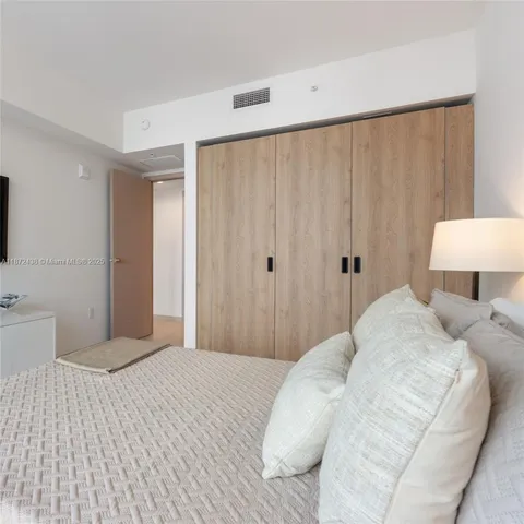 a metallic refrigerator freezer sitting in a kitchen