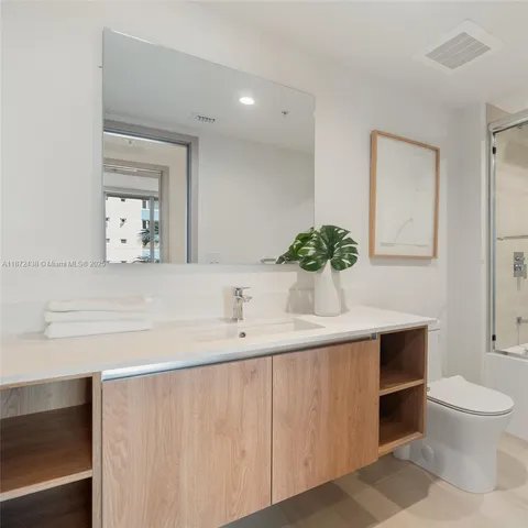 a living room with furniture white walls and flat screen tv