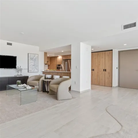 a bedroom with a large window and a bed