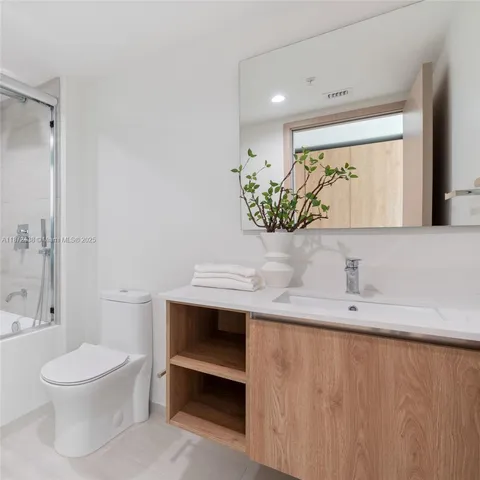 a view of a hallway with wooden shelves