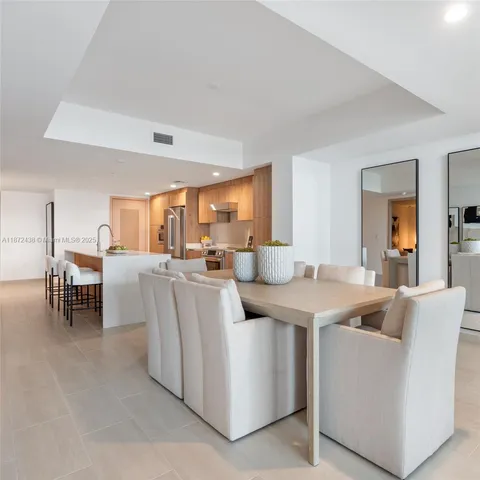 a living room with furniture and flowers