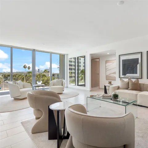 a room with pool table and windows