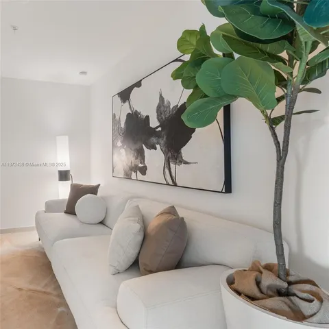 a bedroom with a large bed and a flat screen tv