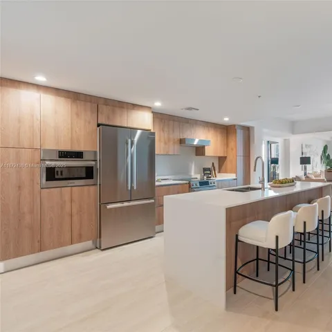 a kitchen with stainless steel appliances granite countertop a sink counter space and cabinets