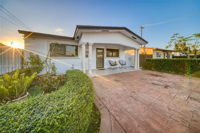 a front view of a house with garden