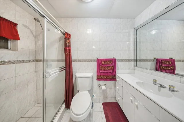 a bathroom with a toilet sink and shower