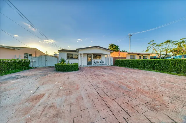 a view of house with yard and green space
