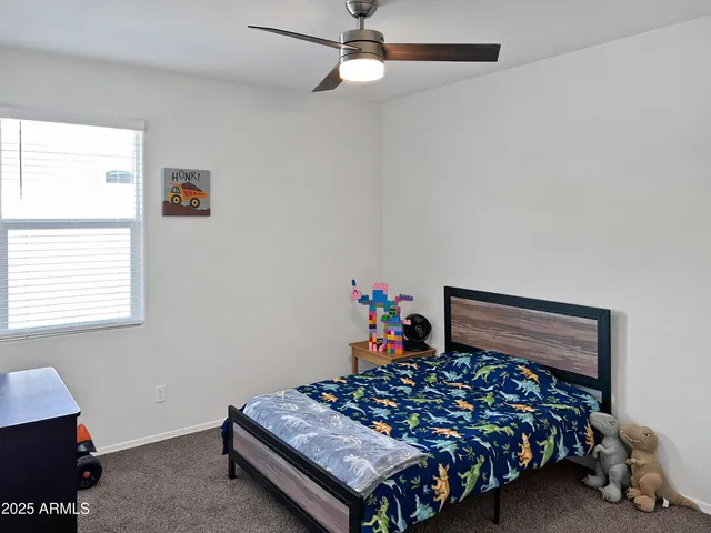 a bed sitting in a bedroom next to a window