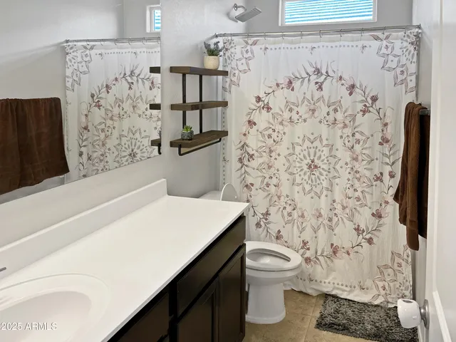 a bathroom with a shower curtain and a toilet