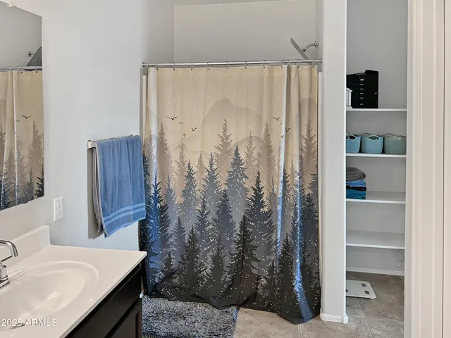 a bathroom with a sink and a shower curtain