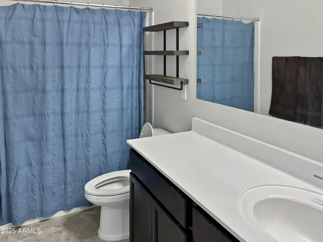 a bathroom with a toilet and a sink