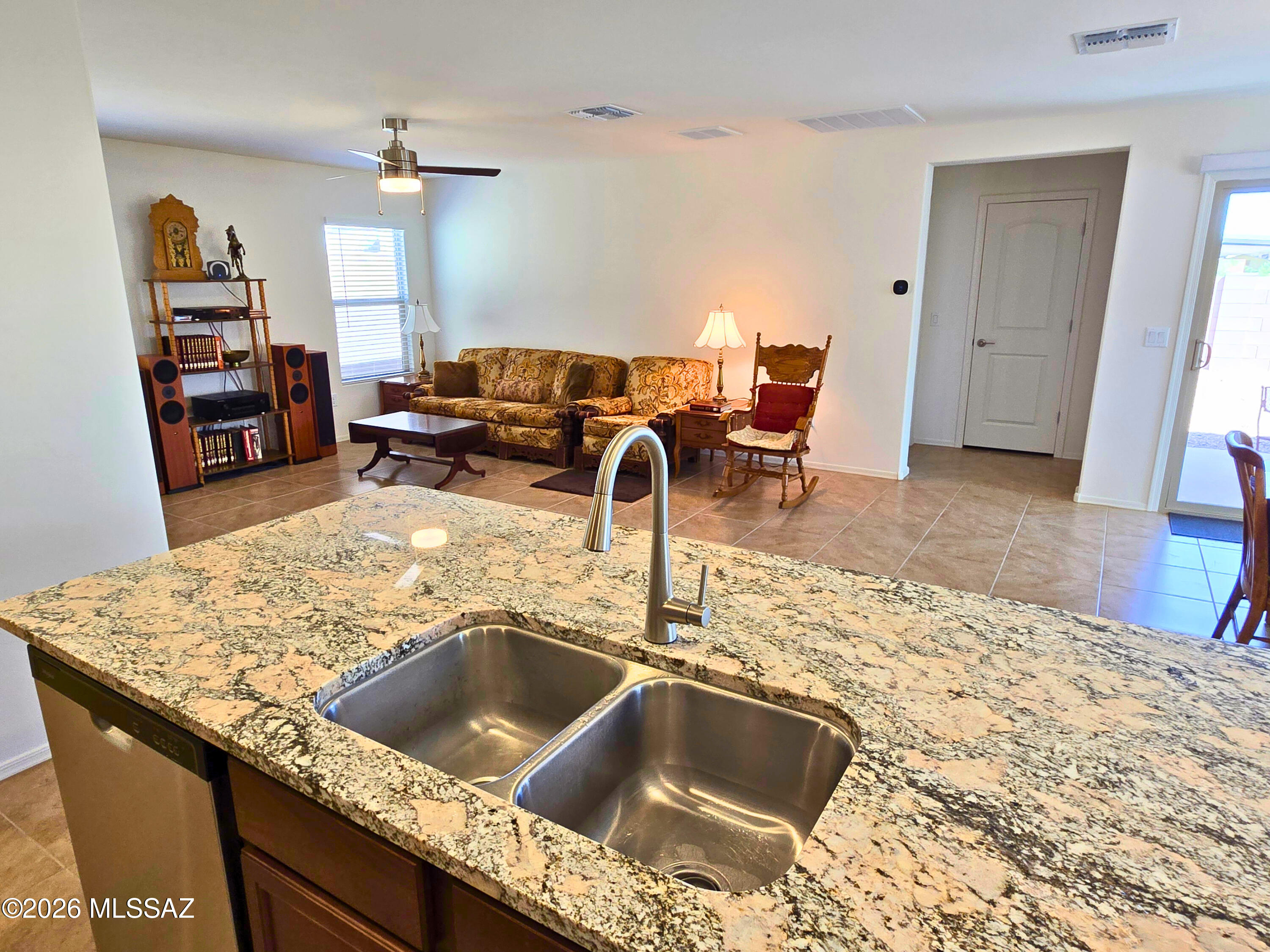 6343 South Rigby Way Tucson, AZ 85746 - Photo 3 of 29 a kitchen view with granite countertop sink and natural light