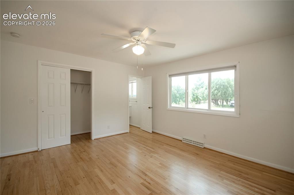 4710 Limestone Road Monument, CO 80132 - Photo 21 of 50 a view of an empty room with wooden floor and a window