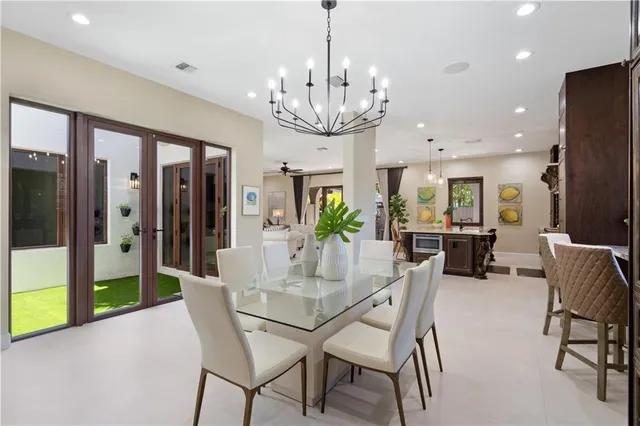 a view of a dining room with furniture a chandelier and wooden floor