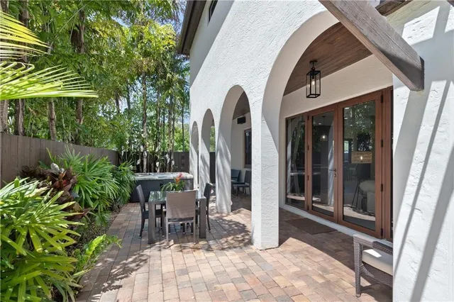 a view of a patio with a dining table and chairs with wooden floor