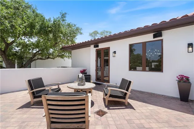 a view of a hallway with windows and chandelier