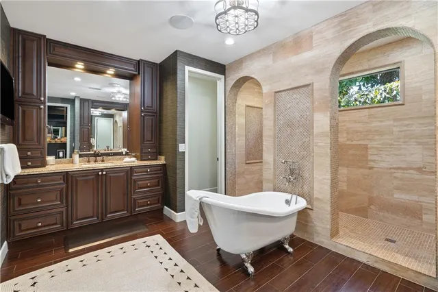 a bathroom with a sink a mirror and a bathtub