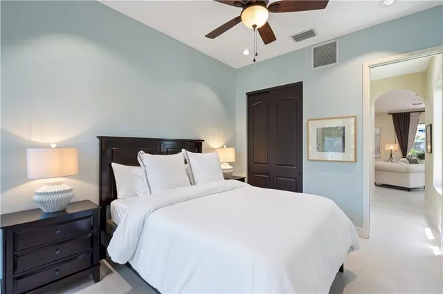 a bedroom with a large bed and a window