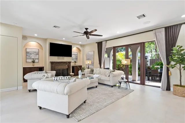 a living room with furniture a fireplace and a flat screen tv