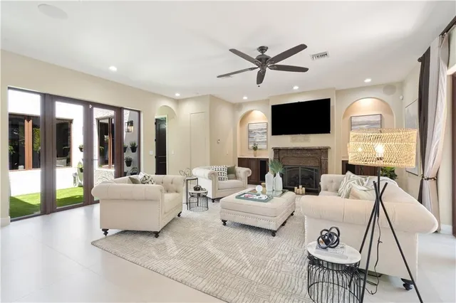 a living room with fireplace furniture and a flat screen tv