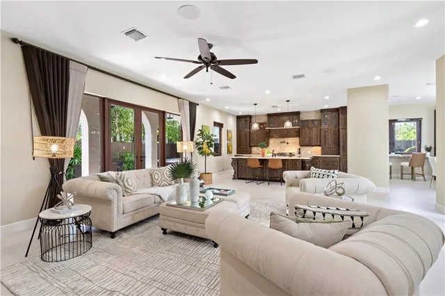 a living room with furniture ceiling fan and a window