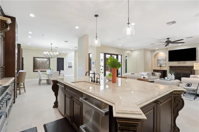 a kitchen with sink stove and chairs