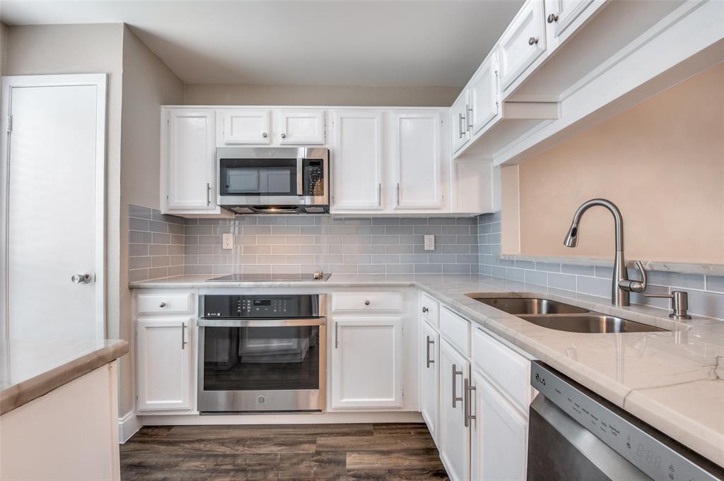 a kitchen with sink a microwave and stove