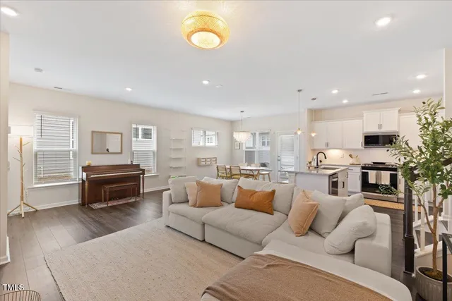 a living room with furniture and a wooden floor
