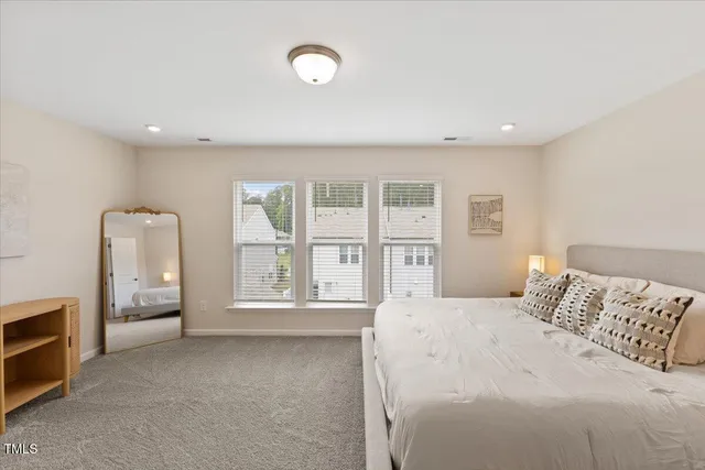 a bedroom with a bed and a large window