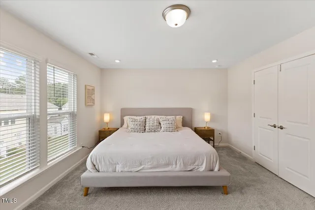 a bedroom with a bed and a large window