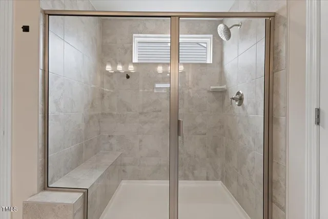 a bathroom with a glass shower door