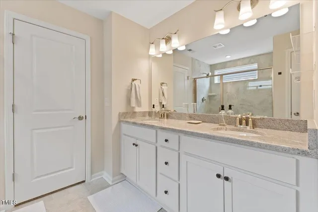 a bathroom with a double vanity sink and a mirror