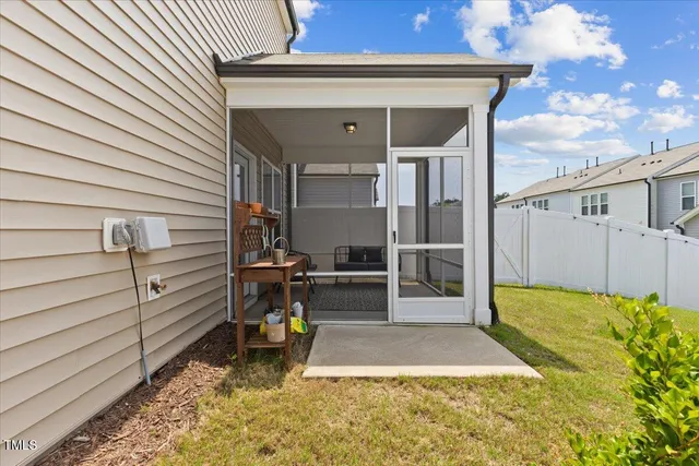 a view of a house with backyard and porch