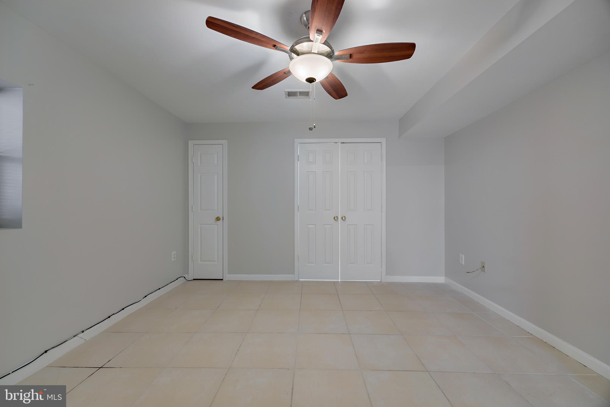 16729 Queen Anne Road Upper Marlboro, MD 20774 - Photo 25 of 29 an empty room with ceiling fan