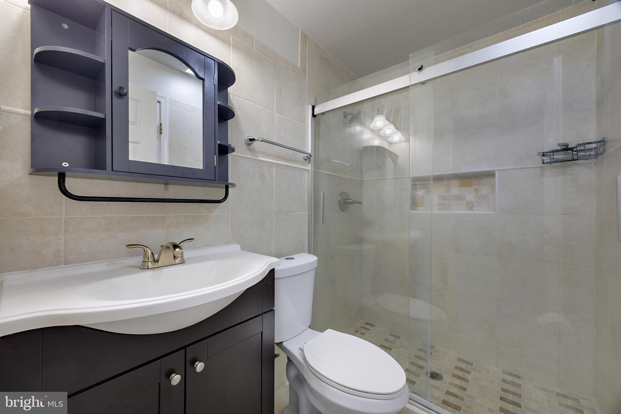 16729 Queen Anne Road Upper Marlboro, MD 20774 - Photo 28 of 29 a bathroom with a sink a toilet and shower