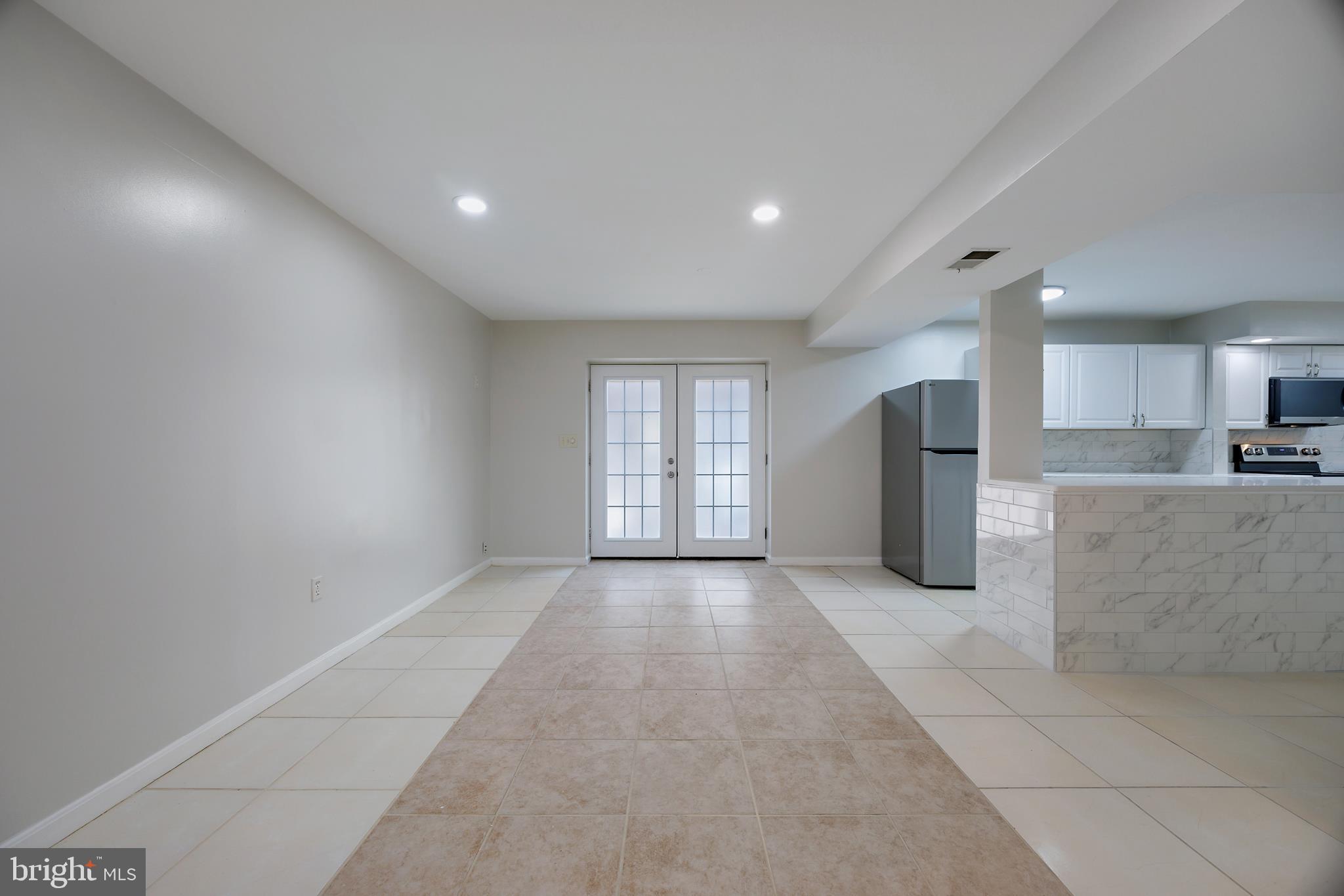 16729 Queen Anne Road Upper Marlboro, MD 20774 - Photo 3 of 29 a view of a kitchen with refrigerator and windows