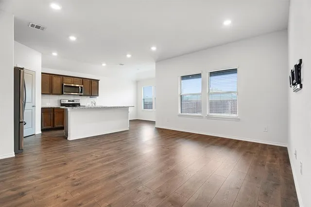 a view of kitchen with microwave and refrigerator