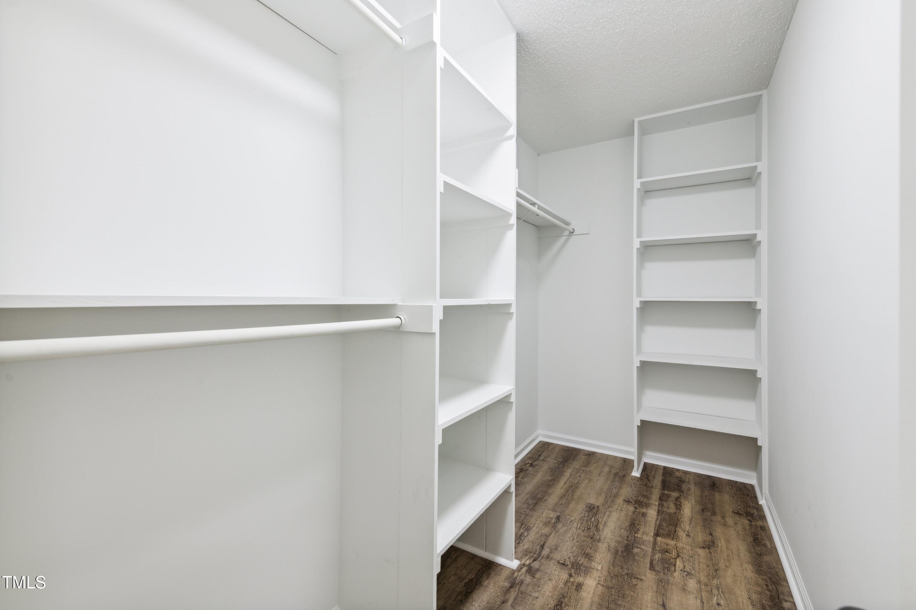 856 Williams-White Road Zebulon, NC 27597 - Photo 13 of 38 a view of walk in closet with empty racks